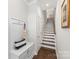 Bright hallway leading to stairs and featuring a bench with storage and coat hooks at 232 Parkwood Ave, Charlotte, NC 28206