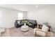 Living room featuring a large couch, large rug, and a cozy sitting area with natural light at 232 Parkwood Ave, Charlotte, NC 28206