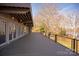 Large back deck featuring black metal railings, wood flooring and views of the wooded backyard at 2700 River Ridge Pl, Fort Mill, SC 29708