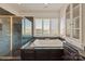 Elegant primary bathroom with a soaking tub, glass shower, and vanity with marble counters at 2700 River Ridge Pl, Fort Mill, SC 29708