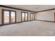 Expansive bedroom with neutral carpet, recessed lights, and three sets of french doors to a balcony at 2700 River Ridge Pl, Fort Mill, SC 29708