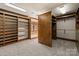 Custom walk-in closet with shelving, cabinets, and wardrobe with dressing mirror at 2700 River Ridge Pl, Fort Mill, SC 29708