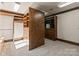 Walk-in closet featuring custom wood shelving, cabinets, and built-in drawers for organized storage at 2700 River Ridge Pl, Fort Mill, SC 29708