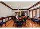 Formal dining room with hardwood floors, wood trim, chandelier, and natural light at 2700 River Ridge Pl, Fort Mill, SC 29708