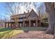 Back exterior featuring a walk out basement and large sunroom at 2700 River Ridge Pl, Fort Mill, SC 29708