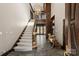 Grand foyer with slate tile flooring, carpet stairs, and detailed woodwork at 2700 River Ridge Pl, Fort Mill, SC 29708