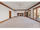 Spacious living room with a fireplace, crown moulding, and french doors to an outdoor balcony at 2700 River Ridge Pl, Fort Mill, SC 29708