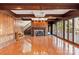Open living room featuring a stone fireplace, wood trim, hardwood floors, and staircase at 2700 River Ridge Pl, Fort Mill, SC 29708