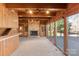 Cozy living room with stone fireplace, wood paneling, and large windows at 2700 River Ridge Pl, Fort Mill, SC 29708
