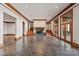 Open living space with tile flooring, a fireplace, and multiple sets of french doors to a lake view at 2700 River Ridge Pl, Fort Mill, SC 29708