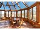 Bright sunroom with walls of windows, views of the lake, and a ceiling fan at 2700 River Ridge Pl, Fort Mill, SC 29708