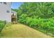 Large, fenced backyard with lush greenery, including a view of the home's deck and patio at 2864 Park Ridge Blvd, Rock Hill, SC 29732