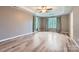 Spacious main bedroom featuring tray ceiling, wood floors, and two windows at 2864 Park Ridge Blvd, Rock Hill, SC 29732