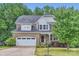 Charming two-story home with a brick facade, attached garage, and well-manicured front yard at 2864 Park Ridge Blvd, Rock Hill, SC 29732