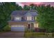 Charming two-story home with a brick facade, attached garage, and well-manicured front yard at dusk at 2864 Park Ridge Blvd, Rock Hill, SC 29732