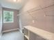 Laundry room features tile floors, storage shelf, hanging rack, and a window at 2864 Park Ridge Blvd, Rock Hill, SC 29732