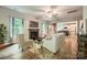 Bright living room with a fireplace, hardwood floors, and a view into the kitchen and dining area at 2864 Park Ridge Blvd, Rock Hill, SC 29732