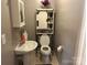 A half-bathroom with pedestal sink and tiled floor at 3186 Catawba St, Claremont, NC 28610