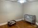 This bedroom has hardwood flooring and a gray-painted accent wall at 3186 Catawba St, Claremont, NC 28610