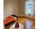 Bedroom with hardwood floors, white trim, and a light-filled window at 3186 Catawba St, Claremont, NC 28610