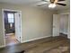 Bedroom with vinyl floors and open door to an ensuite bath at 3186 Catawba St, Claremont, NC 28610