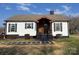 Home exterior featuring a covered porch and neatly graveled front yard at 3186 Catawba St, Claremont, NC 28610
