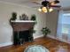 Living room features a brick fireplace and hardwood floors at 3186 Catawba St, Claremont, NC 28610