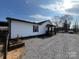 Well-maintained white home with a gravel driveway and tasteful landscaping at 3186 Catawba St, Claremont, NC 28610