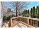 Wood deck with railings overlooking the manicured backyard and beautiful landscaping at 319 Ohenry Ave, Davidson, NC 28036