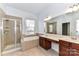 Bright bathroom features a double vanity, soaking tub, and a glass-enclosed shower for modern convenience at 319 Ohenry Ave, Davidson, NC 28036