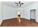 Well-lit bedroom features hardwood floors, a ceiling fan, and connects to a bathroom at 319 Ohenry Ave, Davidson, NC 28036