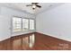 Spacious bedroom with a ceiling fan, large window, and hardwood floors, offers comfortable living space at 319 Ohenry Ave, Davidson, NC 28036