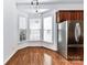 Bright breakfast nook with hardwood floors, stainless steel refrigerator, and a large window offering lots of light at 319 Ohenry Ave, Davidson, NC 28036