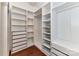 Organized walk-in closet with built-in shelving and drawers, offering ample storage solutions at 319 Ohenry Ave, Davidson, NC 28036