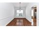 Elegant dining room with hardwood floors, white walls, large window, and contemporary lighting at 319 Ohenry Ave, Davidson, NC 28036