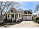 Charming home with a welcoming front porch, columns, and two-car garage at 319 Ohenry Ave, Davidson, NC 28036