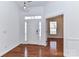 Bright foyer with hardwood floors, white walls, and modern lighting, creating an inviting entrance to the home at 319 Ohenry Ave, Davidson, NC 28036