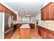 Well-appointed kitchen featuring stainless steel appliances, granite countertops, and rich wood cabinetry, open to the living area at 319 Ohenry Ave, Davidson, NC 28036