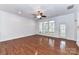 Spacious living room featuring hardwood floors, white walls, and large windows that flood the space with natural light at 319 Ohenry Ave, Davidson, NC 28036