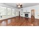 Bright living room with hardwood floors, white walls, large windows, and a modern fireplace, creating a cozy atmosphere at 319 Ohenry Ave, Davidson, NC 28036