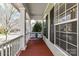 Relaxing porch swing on the covered front porch, perfect for enjoying the neighborhood views and sunny days at 319 Ohenry Ave, Davidson, NC 28036