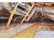View of the attic with insulation material and a wooden pathway for maintenance access at 332 Shiloh S Rd, York, SC 29745