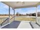 Inviting back porch with a serene view of the surrounding green yard and blue sky at 332 Shiloh S Rd, York, SC 29745