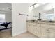 This bathroom has a double vanity, neutral cabinets, and a view to the main bedroom at 332 Shiloh S Rd, York, SC 29745