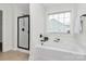 This bathroom features a soaking tub, a shower with a glass enclosure, and a window at 332 Shiloh S Rd, York, SC 29745