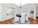 Bright dining room featuring hardwood floors, a large window, and a round table with white upholstered chairs at 332 Shiloh S Rd, York, SC 29745