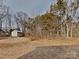 The backyard features trees and an unfinished shed in the background at 3608 Shadowcrest Dr, Concord, NC 28027