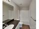 Bathroom with a shower-tub combo, black countertop, and a single window at 3608 Shadowcrest Dr, Concord, NC 28027