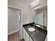 Bathroom with dark countertops, a large mirror, and a view to the hallway at 3608 Shadowcrest Dr, Concord, NC 28027