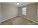 Neutral bedroom featuring a window, neutral carpet, and plenty of natural light at 3608 Shadowcrest Dr, Concord, NC 28027